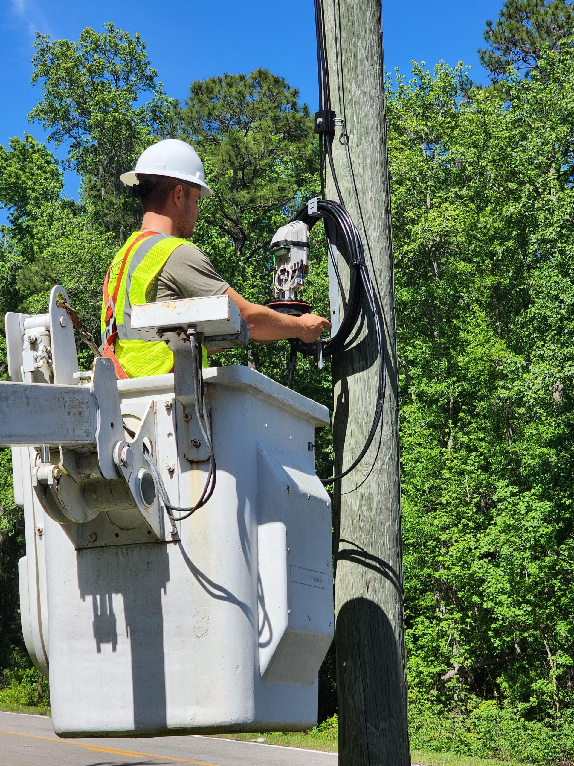 Aerial lineman working in bucket truck